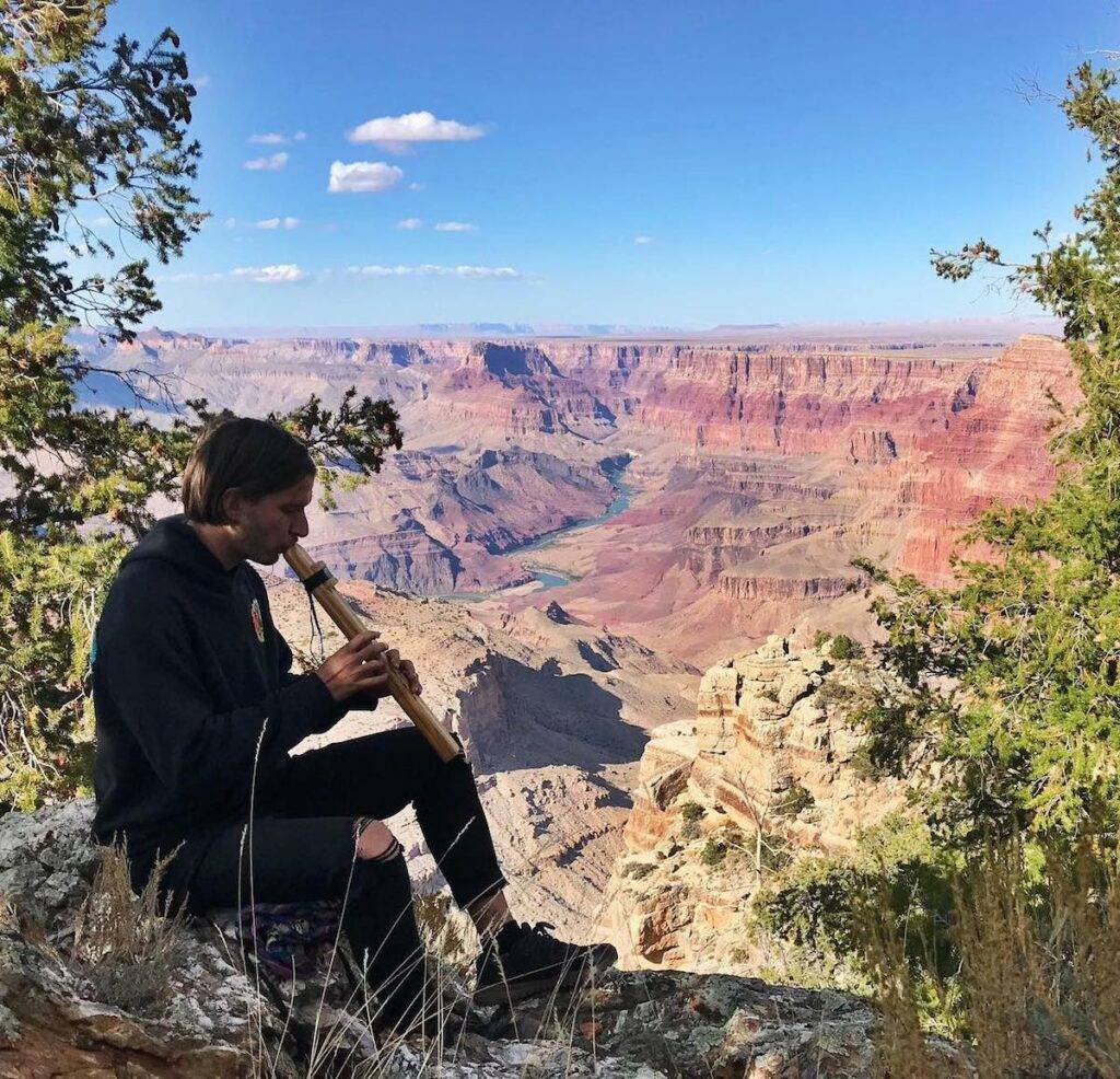 Noah Klein playing the flute at the Grand Canyon .