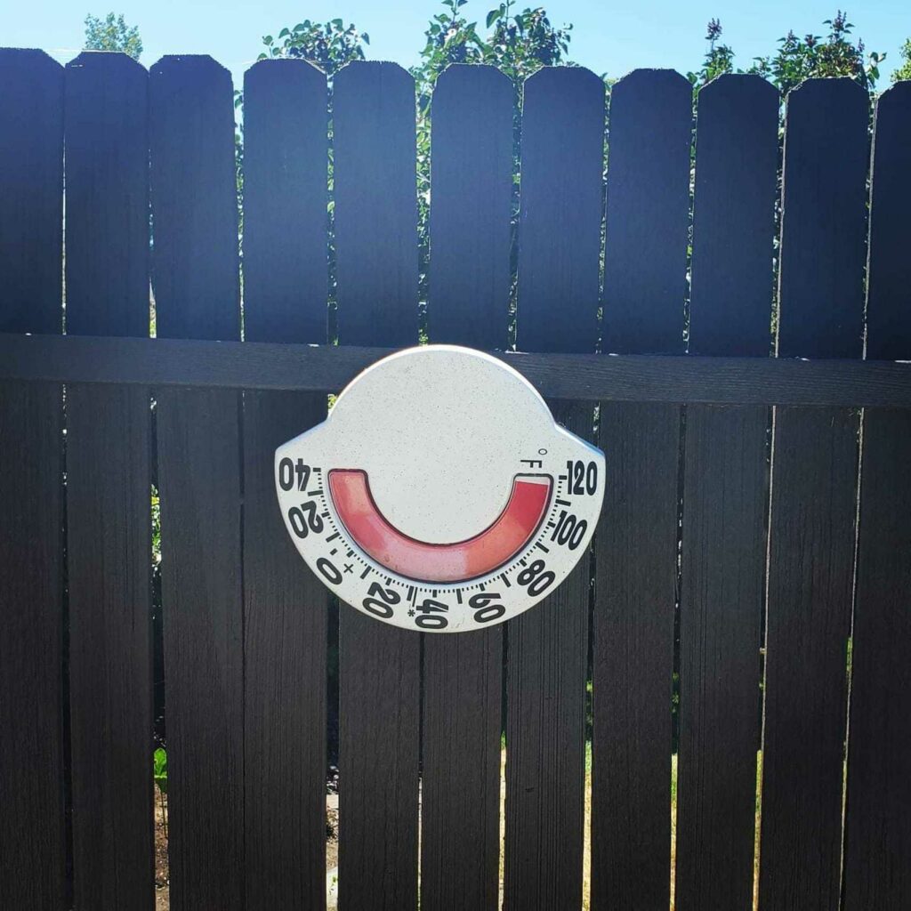 outdoor thermometer on fence