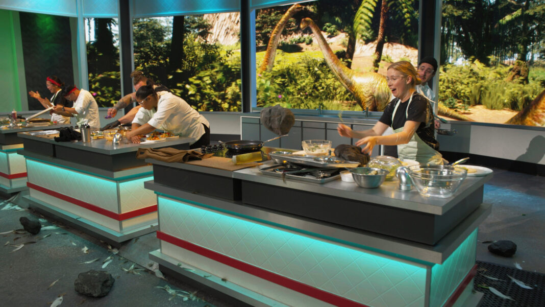 chefs cooking in dinosaur themed kitchen