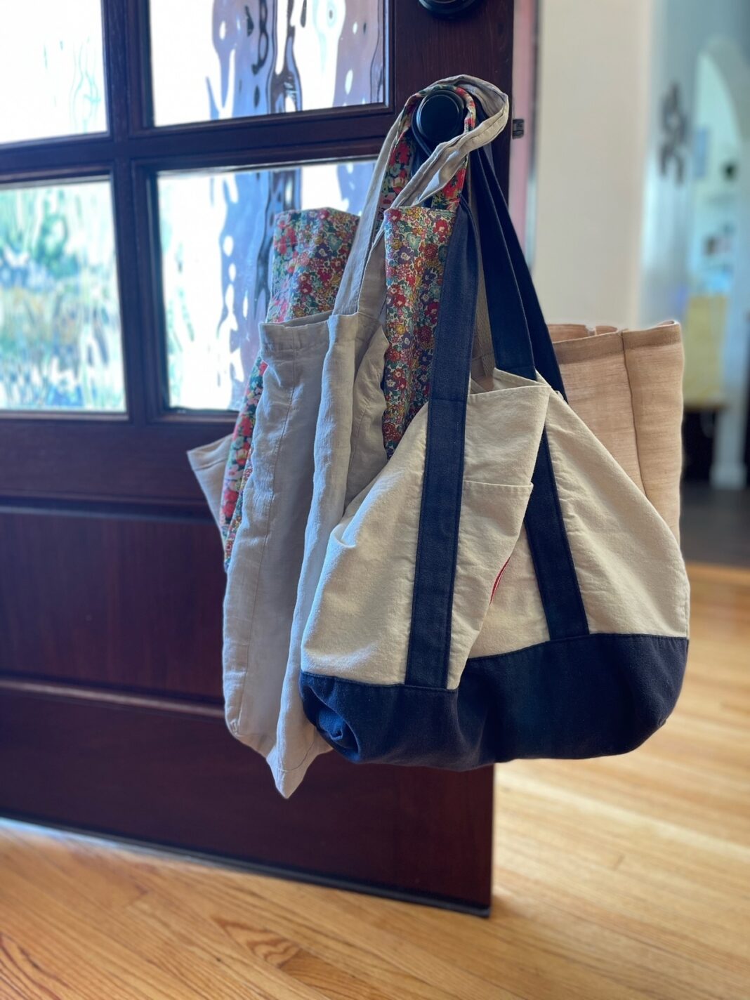 reusable cloth bags hanging on door know