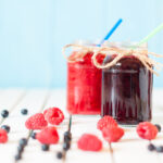 Red and purple drinks in mason jars.
