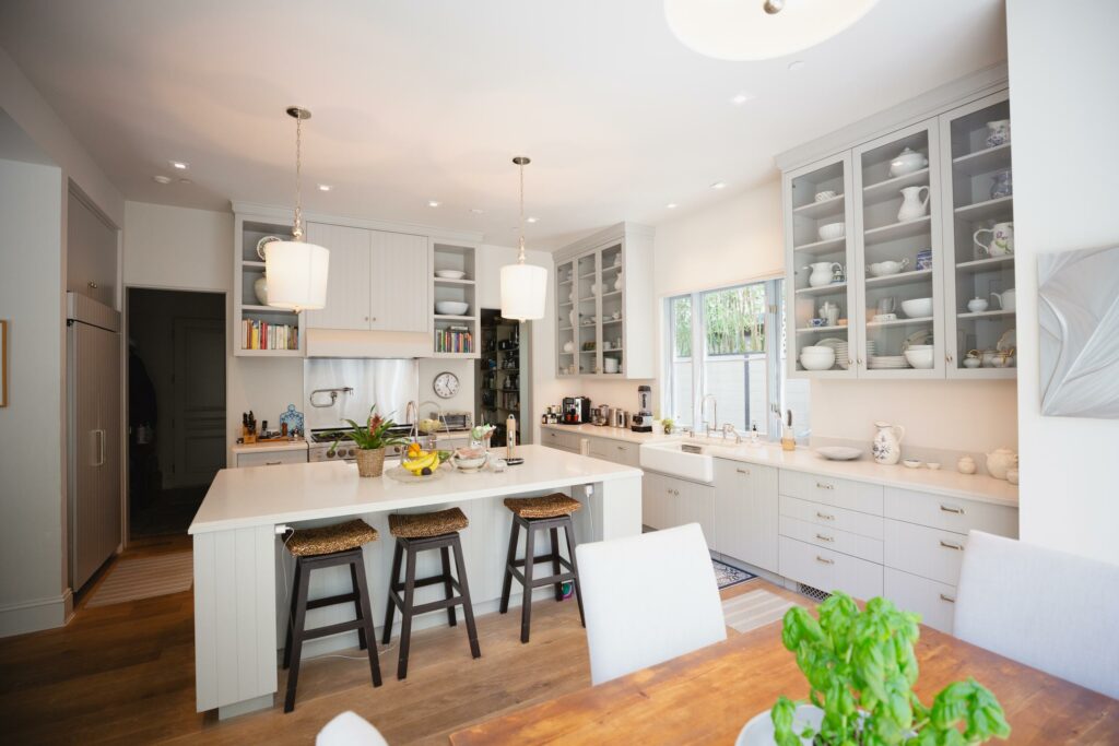 white kitchen with breakfast bar, stools, cabinets