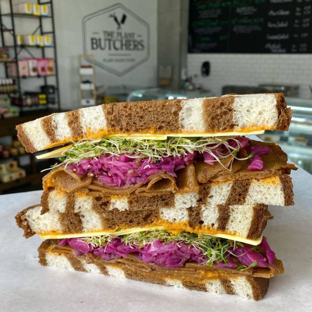 vegan rueben sandwich halves on top of each other in cafe
