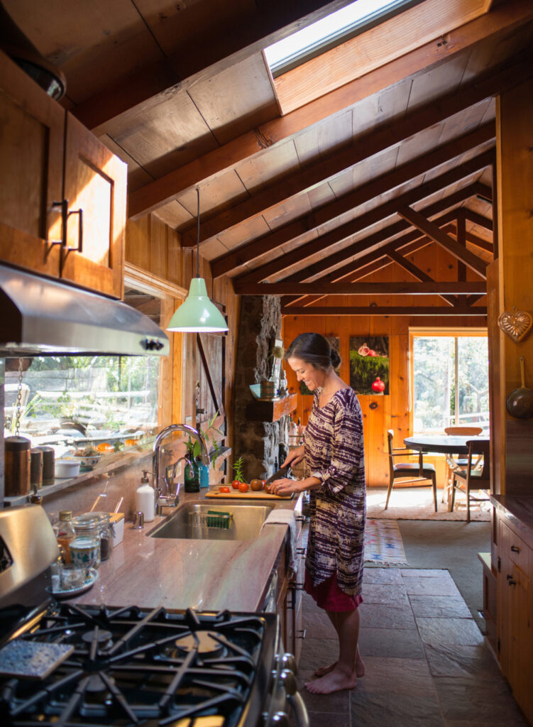 woman prepping vegetables in cabin kitchen